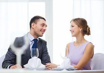 Image showing smiling couple looking at each other at restaurant