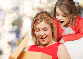 Image showing smiling mother and daughter with gift box