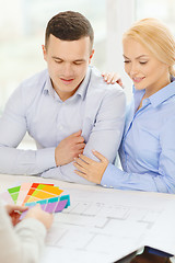 Image showing couple looking at blueprint and color samples