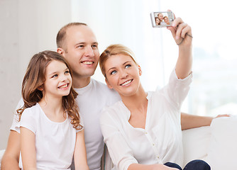 Image showing happy family with little girl making self portrait