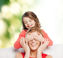 Image showing smiling mother and daughter making a joke