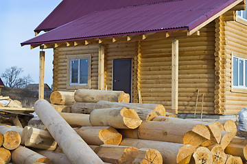 Image showing Wooden house and a bunch of logs