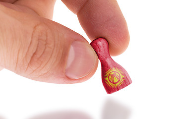 Image showing Wooden pawn with a painting of a flag