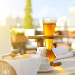 Image showing Kwak beer on the served table. Outdoors photo.