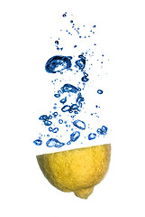 Image showing lemon and lime dropped into water with bubbles isolated on white