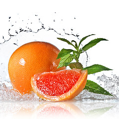 Image showing Water splash on grapefruit with mint isolated on white