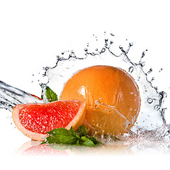 Image showing Water splash on grapefruit with mint isolated on white