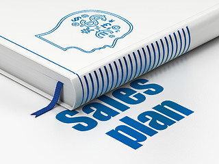 Image showing Advertising concept: book Head With Finance Symbol, Sales Plan on white background