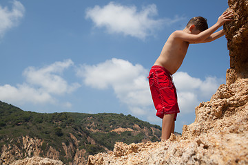 Image showing Little boy climbing up