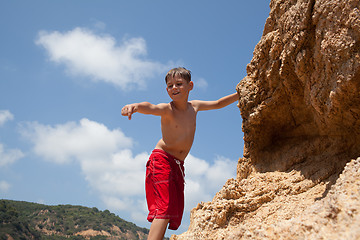 Image showing Little boy climbing up