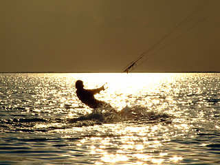 Image showing Silhouettes kitesurf on a gulf on a sunseet