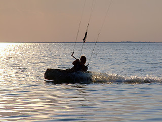 Image showing Silhouettes kitesurf on a gulf on a sunset 2