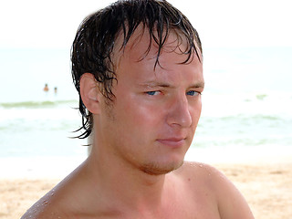 Image showing Portrait of a wet young man day at the beach