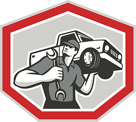 Image showing Automotive Mechanic Carrying Pick-Up Truck