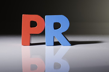 Image showing Multicolored word PR made of wood.