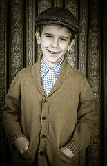 Image showing Smiling child in vintage clothes and hat