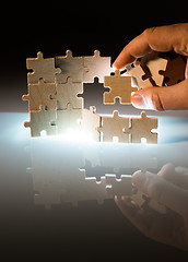 Image showing Wooden puzzle and backlight background. Close up