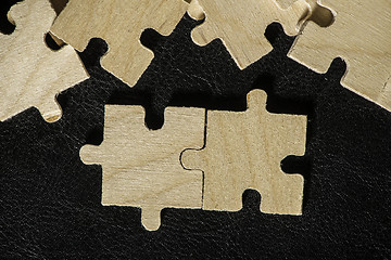 Image showing Wooden puzzle on black background