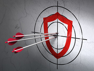 Image showing Protection concept: arrows in Contoured Shield target on wall background