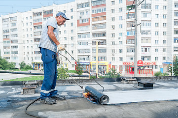 Image showing Worker make waterproofing of seams on the bridge