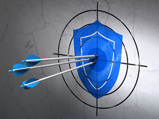 Image showing Protection concept: arrows in Shield target on wall background