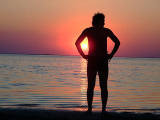 Image showing A black silhouette of a young guy on a sunset 1