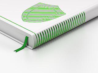 Image showing Protection concept: closed book, Shield on white background