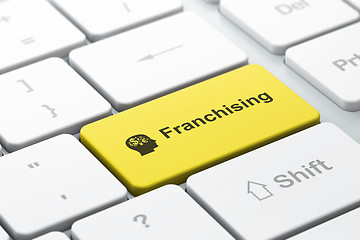 Image showing Business finance concept: Head With Finance Symbol and Franchising on computer keyboard background