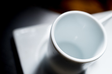 Image showing White cup on dark table