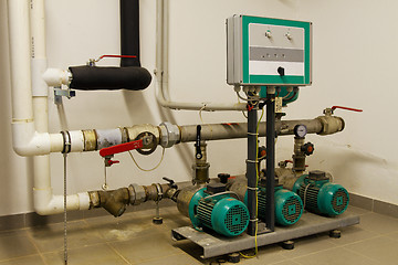 Image showing Water pipes in the boiler room and electric motors