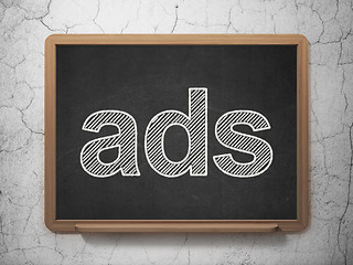 Image showing Advertising concept: Ads on chalkboard background