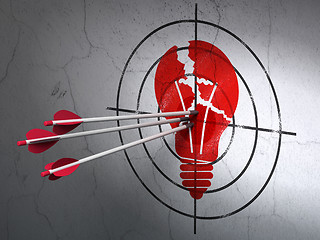 Image showing Business concept: arrows in Light Bulb target on wall background