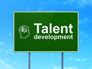 Image showing Education concept: Talent Development and Head With Finance Symbol on road sign background