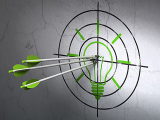 Image showing Finance concept: arrows in Light Bulb target on wall background