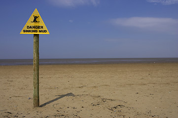 Image showing Danger sinking mud sign, sand point beach England uk