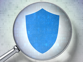 Image showing Protection concept: Shield with optical glass on digital background