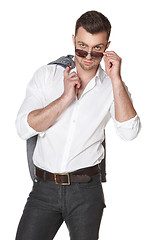 Image showing Businessman peering over the rim of sunglasses