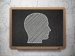 Image showing Advertising concept: Head on chalkboard background