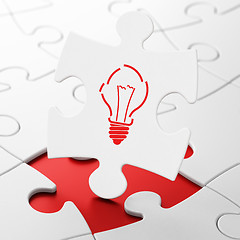 Image showing Finance concept: Light Bulb on puzzle background