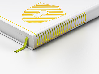 Image showing Protection concept: closed book, Shield With Keyhole on white background