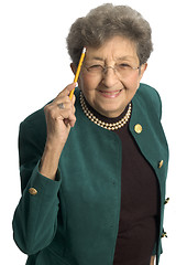 Image showing healthy senior woman pointing to head