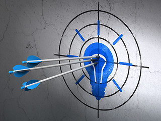 Image showing Finance concept: arrows in Light Bulb target on wall background