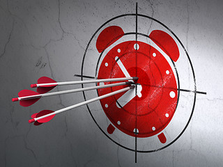 Image showing Timeline concept: arrows in Alarm Clock target on wall background