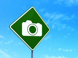 Image showing Vacation concept: Photo Camera on road sign background