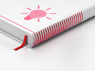 Image showing Finance concept: closed book, Light Bulb on white background