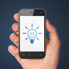 Image showing Finance concept: Light Bulb on smartphone