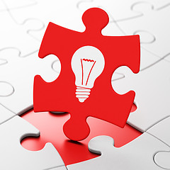 Image showing Finance concept: Light Bulb on puzzle background