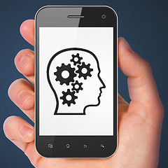 Image showing Finance concept: Head With Gears on smartphone