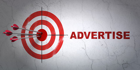 Image showing Advertising concept: target and Advertise on wall background