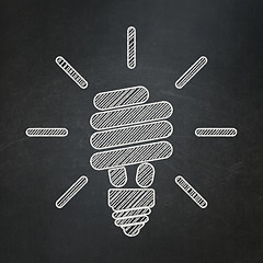 Image showing Finance concept: Energy Saving Lamp on chalkboard background